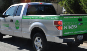 Balance Fitness corporate wrap with tailgate, side logos, lettering, and hood logo.
