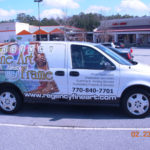 Fine Art and Frame corporate van wrap with custom graphics, lettering, and windows.