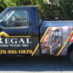Regal corporate full wrap with hood and side logos, custom graphics, and lettering.