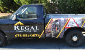 Regal corporate full wrap with hood and side logos, custom graphics, and lettering.
