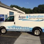 Aqua Restoration corporate wrap with windows, logos, and lettering.